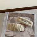Detailed view of two beige plush rectangular hair clips on a CD case and fabric - Khaki (2Pcs/Set)