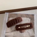 Detail view of a pair of brown fuzzy plush hair clips with wavy texture on a beige fabric - Brown (2Pcs/Set)