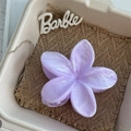 Close-up of a purple marble-patterned flower hair claw clip with glossy finish - Purple