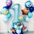 Detail view of ocean-themed 1st birthday balloon set with number 1 and cartoon sea creatures - Number 1