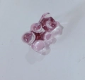 Single purple resin gummy bear brooch pin accessory on a white reflective surface - Transparent Light Pink
