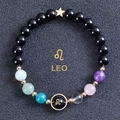 Detail of Leo zodiac bead bracelet with gold star pendant and colorful beads on dark background - Leo-Obsidian