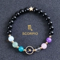 Detailed shot of Scorpio beaded bracelet with black stones and golden constellation charm - Scorpio-Obsidian