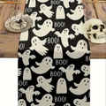Close-up of Halloween linen table runner with white ghosts and BOO patterns on wood table - Black and White Full Print Ghost BOO