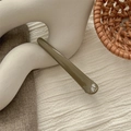 Olive green seamless duckbill hair clip displayed on a minimalist white wavy pedestal - Glossy Brown