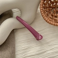 Detailed view of long plum purple seamless hair clip on elegant white ceramic prop - Bright Rose