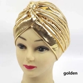 Close-up of golden metallic turban hat on mannequin head showing shiny fabric texture - One Size / Gold