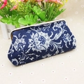 Detailed view of dark blue floral coin purse with vintage metal clasp closure - Blue