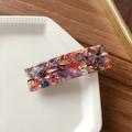 Modern rectangular acetate hair clip featuring a colorful marble texture in a ceramic tray - Mixed Purple