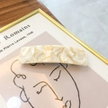 Minimalist 8.5cm cream marble acetate hair clip displayed on an artistic frame - Off White