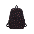 Detail of corduroy backpack texture with cute red strawberry patterns on black fabric - Black