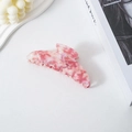 Macro view of pink marble acetate hair claw clip with glossy crescent moon shape - Pink Floral