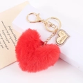 Macro view of red faux fur heart keychain with gold I Love You engraved pendant - Red