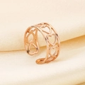 Macro detail of rose gold heart-shaped hollow-out open ring on beige silk background - Hollow Heart Style (KR105012-KFC)