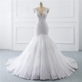 Elegant white mermaid bridal gown with deep V-neck, lace appliques, and luxury sequin details - US 2 / White