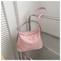 Detail of pink nylon shoulder bag displayed on a modern minimalist metallic rack - Pink
