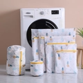 Detail of pineapple print laundry bags with fine mesh and yellow zippers in laundry room - 40*50cm / Pineapple