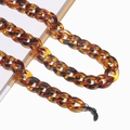 Close-up of leopard pattern acrylic eyeglass chain with amber links and non-slip rubber loop - Brown Leopard