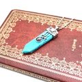 Detail of a vintage turquoise hexagonal sword necklace with purple gemstone accents - Blue Turquoise