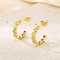 Macro shot of gold-plated C-shaped earrings with sparkling square cubic zirconia studs - Gold Clear Square Zirconia Style (KE116220-KFC)