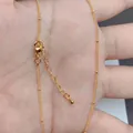 Detail of 18K gold-plated O-chain with lobster clasp, extender chain and small bead accents - Fine Chain with Drop Pendant