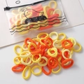 Elastic hair bands in yellow and orange set with a cartoon duck matte storage bag - 100 Pieces Set / Yellow Series