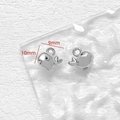 Macro shot of silver whale metal pendants with 10mm and 9mm dimension markers - Whale