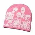 Detailed close-up of a pink knitted beanie with a white skeleton bone pattern - White Skull-Pink