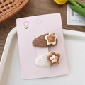 Close-up of plush velvet star hair clips on card with a minimalist aesthetic design - Star Cloth Drop Style
