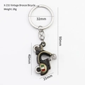 Vintage bronze scooter motorcycle keychain with Italian flag detail and metal ring - Bronze