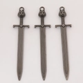 Close-up of three antique silver sword charms with cat head design for DIY jewelry making - Gun Black