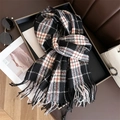 Detailed view of soft plaid scarf with tassels, styled with fashion accessories in a tray - 208x66cm / Black Red