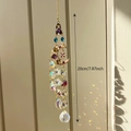 Golden moon suncatcher with purple and blue crystals showing rainbow light refraction - Colorful Moon
