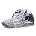 Baseball cap featuring vintage black and white newspaper print with curved brim - White