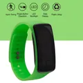 Macro shot of digital sports watch with neon green silicone strap and LED display functions - Green