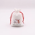 Detail of Christmas white linen gift bags with red ribbons and festive cartoon prints - Reindeer and Santa / 10*14cm