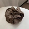 Close-up of a large brown satin silk scrunchie with layered ruffles and soft glossy finish - 16cm / Dark Camel