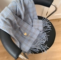 Blue plaid winter scarf with tassel fringe and heart embroidery detail on a chair - Small Heart Blue