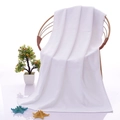 White premium cotton hotel bath towel with soft textured fabric hanging on chair - 21-ply Yarn 40g 30*30cm