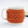 Handmade orange crochet mug sleeve with cable knit pattern and wooden button detail - Orange with Button