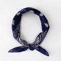 Navy blue square scarf with white paisley pattern tied in a stylish circular knot - Paisley Navy