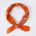 Orange square silk scarf featuring a classic paisley print and elegant knotted style - Paisley Orange Red