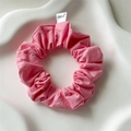 Detailed macro view of pink cotton scrunchie with FMdrea label in a white decorative dish - Pink