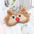 Cute plush reindeer sleep mask with gold antlers and red sequin nose on a magazine background - Khaki Reindeer