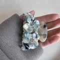 Detail of floral acetate hair claw with blue marble texture and rhinestone accents - 7cm / Light Green Floral