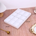Detailed view of white 12-slot jewelry display tray with size dimensions on wood surface - 35*24 Tray 12 Grids