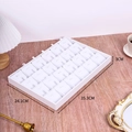 Macro view of white jewelry display tray with dividers on a wooden desk setting - 24 Grids Pendant Tray