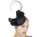 Detail of navy blue Sinamay fascinator hat with large bow and decorative feathers on a model - Navy Blue