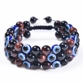 Detailed view of handmade triple layer woven bracelet with tiger eye beads and evil eye charm - Red Tiger Eye + Obsidian + Evil Eye Bracelet