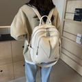 Detail of off-white lychee grain leather backpack with metallic logo and zippers - Off-white
